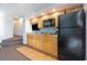 Small galley kitchen with wood cabinets and black appliances at 4800 S Ocean Blvd. # 1007, North Myrtle Beach, SC 29582