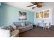 Living room with sofa, chair, and small dining table at 4800 S Ocean Blvd. # 1007, North Myrtle Beach, SC 29582