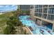 Resort pool area adjacent to building, showing pool and loungers at 4800 S Ocean Blvd. # 1007, North Myrtle Beach, SC 29582