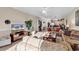 Sunlit living room with comfortable seating and a view into the kitchen and dining area at 4882 Luster Leaf Circle # 202, Myrtle Beach, SC 29577