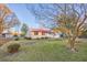 Ranch style brick home with red metal roof and mature trees at 602 Luttie Rd., Myrtle Beach, SC 29588