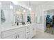 Double vanity bathroom with modern lighting and a large walk-in shower at 838 Sandy Side Dr., Little River, SC 29566