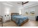 Bright bedroom featuring a comfy bed, ceiling fan, and two large windows at 838 Sandy Side Dr., Little River, SC 29566