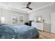Main bedroom with plush bedding, ceiling fan, and ample natural light at 838 Sandy Side Dr., Little River, SC 29566