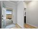 Bright entryway with light wood floors and view of front porch at 838 Sandy Side Dr., Little River, SC 29566