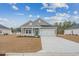 Gray house with white accents, two-car garage, and a landscaped yard at 838 Sandy Side Dr., Little River, SC 29566