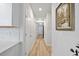 Long hallway with light wood floors and access to other rooms at 838 Sandy Side Dr., Little River, SC 29566
