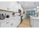 Modern kitchen with white cabinets, quartz countertops, and stainless steel appliances at 838 Sandy Side Dr., Little River, SC 29566