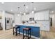 Modern kitchen with white cabinets, blue island, and stainless steel appliances at 838 Sandy Side Dr., Little River, SC 29566