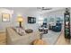 Bright living room with light beige sofa and blue armchairs at 838 Sandy Side Dr., Little River, SC 29566