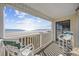 Relaxing balcony with ocean views, white railings and green chairs at 9620 Shore Dr. # 208, Myrtle Beach, SC 29572