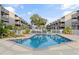 Community pool with surrounding patio and white fence at 9621 Shore Dr. # B-112, Myrtle Beach, SC 29572