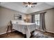 Bright bedroom with a tray ceiling, ceiling fan and decorative rug at 9650 Bradford Ln., Murrells Inlet, SC 29576