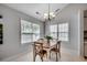 Cozy dining area with a wooden table, four chairs, and ample natural light at 9650 Bradford Ln., Murrells Inlet, SC 29576