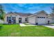 Charming one-story home featuring a well-manicured lawn, neutral siding, and attached garage at 9650 Bradford Ln., Murrells Inlet, SC 29576