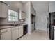 Functional kitchen area featuring white cabinets, neutral floors and standard appliances at 9650 Bradford Ln., Murrells Inlet, SC 29576