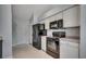 Cozy kitchen featuring white cabinetry and black appliances at 9650 Bradford Ln., Murrells Inlet, SC 29576