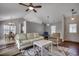 Bright living room with vaulted ceilings, wood floors, stylish furniture, and dining area view at 9650 Bradford Ln., Murrells Inlet, SC 29576