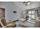 Bright living room featuring vaulted ceilings, wood floors, stylish furniture and a slider door at 9650 Bradford Ln., Murrells Inlet, SC 29576