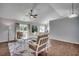 Bright living room with vaulted ceilings, wood floors, stylish furniture, and sliding glass door at 9650 Bradford Ln., Murrells Inlet, SC 29576