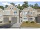 Tan siding two-story townhome with two-car garage and landscaping at 100 Machrie Loop # 17-C, Myrtle Beach, SC 29588