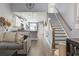 Open living room and kitchen with stylish stairs at 100 Machrie Loop # 17-C, Myrtle Beach, SC 29588