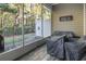 Screened porch with wooded backyard view and patio furniture at 100 Machrie Loop # 17-C, Myrtle Beach, SC 29588