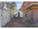 View of backyard featuring a fence and green door, as well as a brick building at 1025 Carolina Rd. # Y-1, Conway, SC 29526