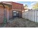 View of backyard featuring a fence and sliding glass doors, as well as a brick building at 1025 Carolina Rd. # Y-1, Conway, SC 29526