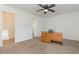 A bright bedroom features neutral carpet, white walls, a ceiling fan and two entryways at 1025 Carolina Rd. # Y-1, Conway, SC 29526