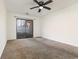 Bedroom features carpet flooring, ceiling fan, and sliding glass door to a small, fenced yard at 1025 Carolina Rd. # Y-1, Conway, SC 29526