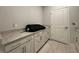 Laundry room with white cabinets and a large countertop at 1108 Oxeye St., North Myrtle Beach, SC 29582