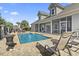 Backyard featuring a luxurious pool, comfortable lounge chairs, and an outdoor fireplace for entertaining at 1422 Bohicket Ct., Myrtle Beach, SC 29579