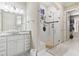 Bright bathroom featuring a glass shower with stone flooring and updated fixtures, alongside a stylish granite vanity at 1422 Bohicket Ct., Myrtle Beach, SC 29579