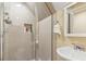 Shower and vanity area with tiled walls, recessed shelving, a glass shower door, and polished chrome fixtures at 1422 Bohicket Ct., Myrtle Beach, SC 29579