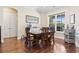 Dining room with hardwood floors, with a window and an elegant light fixture creating an inviting space at 1422 Bohicket Ct., Myrtle Beach, SC 29579