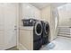 Convenient laundry room featuring modern washer and dryer units with built-in cabinetry for storage at 1422 Bohicket Ct., Myrtle Beach, SC 29579
