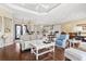 Open-concept living room, connected to a bright kitchen and entry way, features detailed ceiling and hardwood floors at 1422 Bohicket Ct., Myrtle Beach, SC 29579