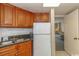 Efficiency kitchen with dark countertop, wood cabinets, and full-size refrigerator at 1501 S Ocean Bl S Ocean Blvd. # 549, Myrtle Beach, SC 29577