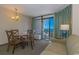 Living room with ocean view, sofa, dining table, and balcony access at 1501 S Ocean Bl S Ocean Blvd. # 549, Myrtle Beach, SC 29577