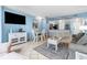 Bright living room with comfy seating, dining area, and large TV at 1605 S Ocean Blvd. # 414, Myrtle Beach, SC 29577