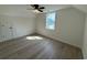 Bright bedroom with wood-look floors, ceiling fan, and a window view at 1718 26Th Ave. N, North Myrtle Beach, SC 29582