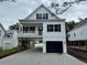 Stylish two-story coastal home with a garage, a covered porch, and a view of neighboring houses at 1718 26Th Ave. N, North Myrtle Beach, SC 29582