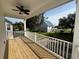 Covered porch with wood flooring, a ceiling fan, and a serene backyard view at 1718 26Th Ave. N, North Myrtle Beach, SC 29582