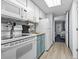 Small kitchen with white appliances and teal cabinets at 2000 N Ocean Blvd. # Ph 3, Myrtle Beach, SC 29577