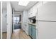 Kitchen with teal cabinets and view into living room at 2000 N Ocean Blvd. # Ph 3, Myrtle Beach, SC 29577