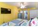 Bedroom with a yellow wall, a bed, and a TV at 205 74Th Ave. N # 709, Myrtle Beach, SC 29572