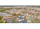 An aerial view showcases a neighborhood with waterfront properties, condo complexes, and a pond with a fountain feature at 2080 Cross Gate Blvd. # 303, Surfside Beach, SC 29575