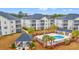 Aerial view of complex featuring a community pool, grilling area, and well-maintained grounds at 2080 Cross Gate Blvd. # 303, Surfside Beach, SC 29575