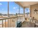 Screened balcony with seating and a view of the surrounding neighborhood and pond at 2080 Cross Gate Blvd. # 303, Surfside Beach, SC 29575